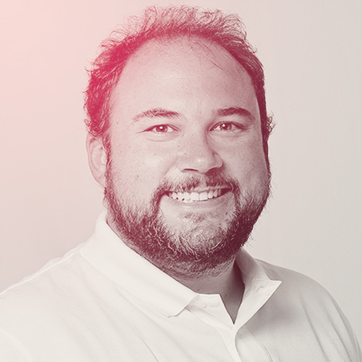 Allen's portrait. A bearded man with a big smile, wearing a white shirt, in a headshot.